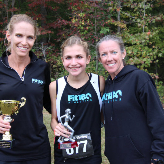 Coach Emily with Coach Lisa and the highest honor top runner