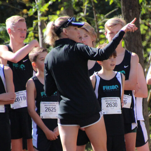 Coach Lisa pointing to the track and field for strategy